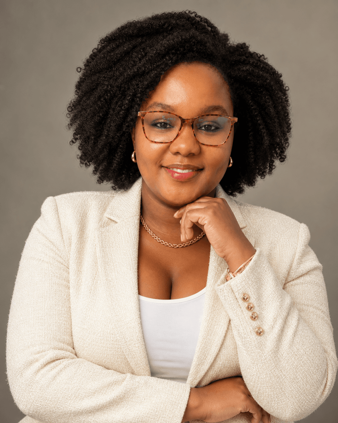 Kagiso in a cream blazer portrait with a calm, direct expression